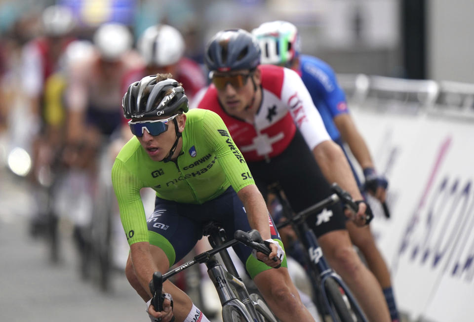 Slovenia's Tadej Pogacar, left, pedals during the Men's Elite Road Race on day four of the 2023 UCI Cycling World Championships in Glasgow, Scotland, Sunday Aug. 6, 2023. (Tim Goode/PA via AP)