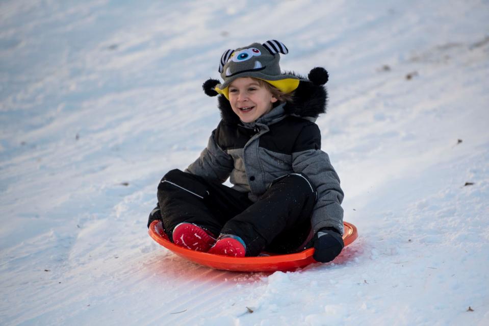 Noah Edrington-Merrill, 6, goes sledding at Leila Arboretum in Battle Creek in January 2022.