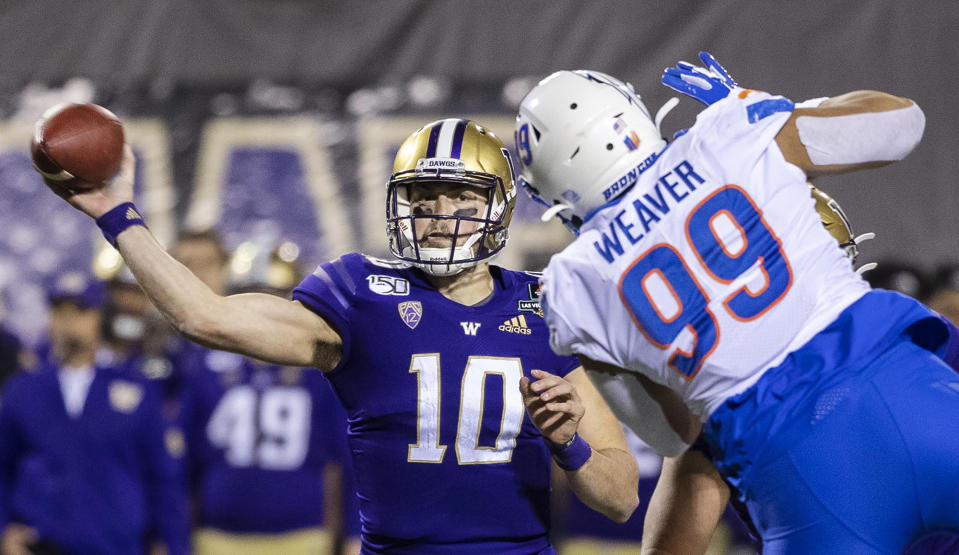 Washington QB Jacob Eason (10) passes around Boise State's Curtis Weaver (99), completing a touchdown pass in the Las Vegas Bowl. (Darin Oswald/Idaho Statesman/Tribune News Service via Getty Images)