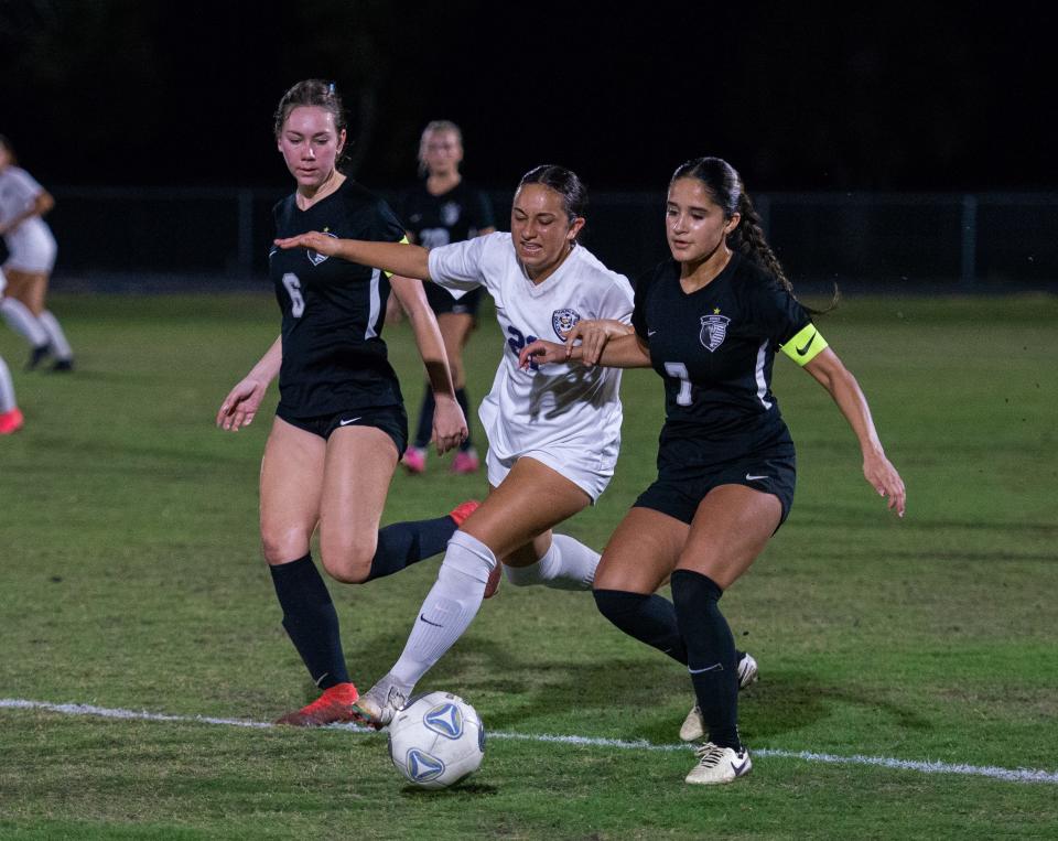 Naples' Laila Albaghdadi battles for the ball between Mariner's Ariana Cintron (7) and Arianna McIntyre (6) during Friday's Region 5A-3 girls soccer semifinal.