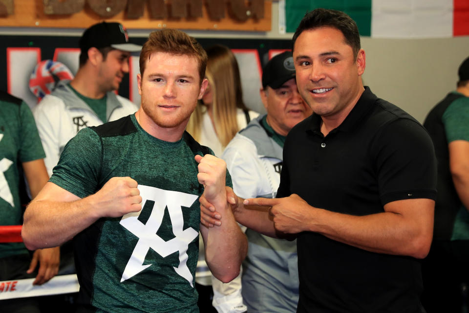 SAN DIEGO, CA - APRIL 25:  WBC middleweight champion Canelo Alvarez poses with Chairman and CEO of Golden Boy Productions Oscar De La Hoya during a media workout at the House of Boxing Gym on April 25, 2016 in San Diego, California.  (Photo by Sean M. Haffey/Getty Images)