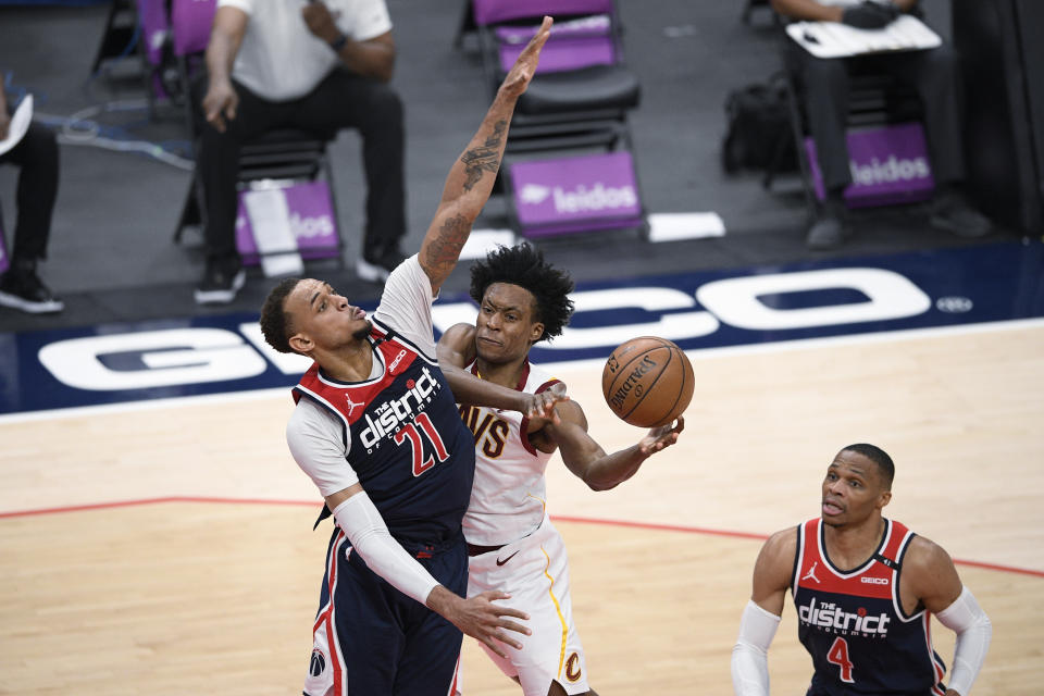 Cleveland Cavaliers guard Collin Sexton, center, goes to the basket against Washington Wizards center Daniel Gafford (21) during the second half of an NBA basketball game, Friday, May 14, 2021, in Washington. Wizards guard Russell Westbrook is at right. (AP Photo/Nick Wass)