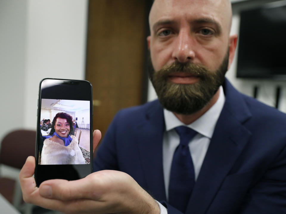 In this Wednesday, June 19, 2019 photo, Eric Ridenhour poses with a photo he took of his fiancee Kiersten Smith after giving an interview in Dallas. Smith was killed in the June 9 crane collapse in downtown Dallas. (AP Photo/Tony Gutierrez)