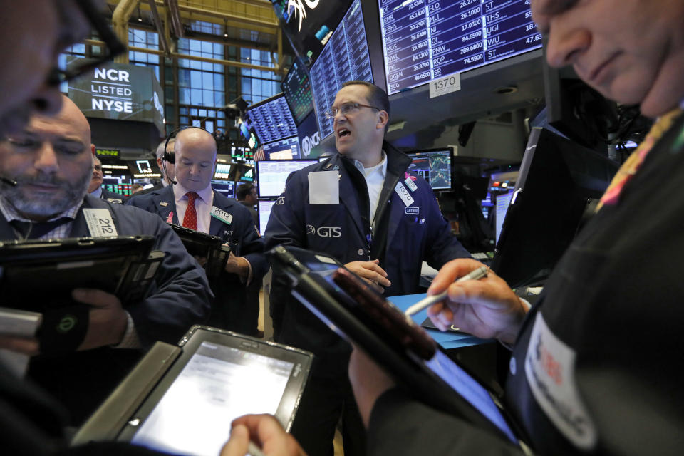 In this Wednesday, Nov. 7, 2018, file photo traders gather at the post of Anthony Matesic, center, on the floor of the New York Stock Exchange. (AP Photo/Richard Drew, File)