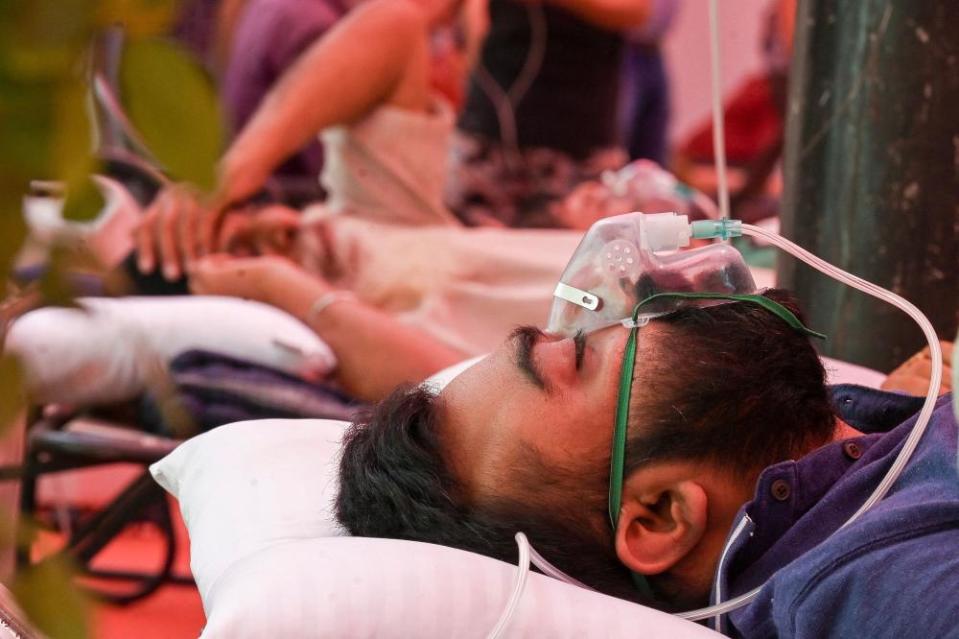 A Covid-19 coronavirus patient breathes with the help of oxygen provided by a Gurdwara, a place of worship for Sikhs on 6 May 2021.