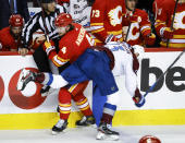 Colorado Avalanche right wing Valeri Nichushkin (13) checks Calgary Flames' Rasmus Andersson during the second period of an NHL hockey game Tuesday, March 29, 2022 in Calgary, Alberta. (Jeff McIntosh/The Canadian Press via AP)