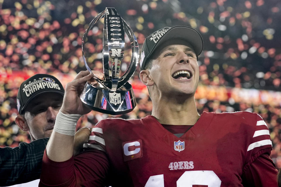 San Francisco 49ers quarterback Brock Purdy celebrates with the trophy after their win against the Detroit Lions in the NFC Championship NFL football game in Santa Clara, Calif., Sunday, Jan. 28, 2024. (AP Photo/Godofredo A. Vasquez)