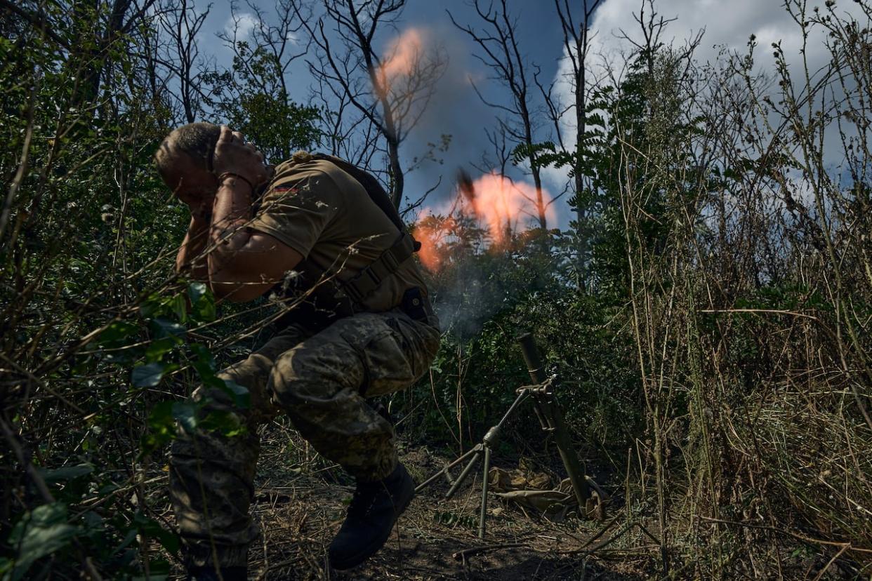 A Ukrainian soldier fires a mortar toward Russian positions near Bakhmut, Donetsk region, Ukraine on Sept. 2, 2023. (AP Photo/Libkos - image credit)