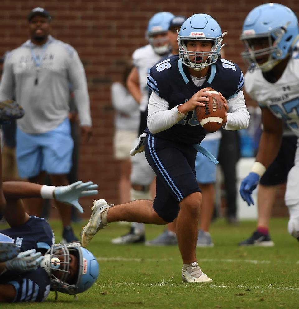 Dorman High School held its Spring football game at the high school on May 18, 2023. Dorman's Blue Team's David Sorensen (16) looks for room to pass on a play.