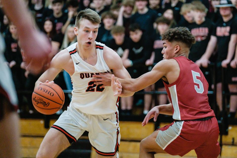 New Phila's Carter Vandall drives around the guard attempt by Dover's Bronson Gilyard, Friday, Feb. 17 in New Philadelphia.