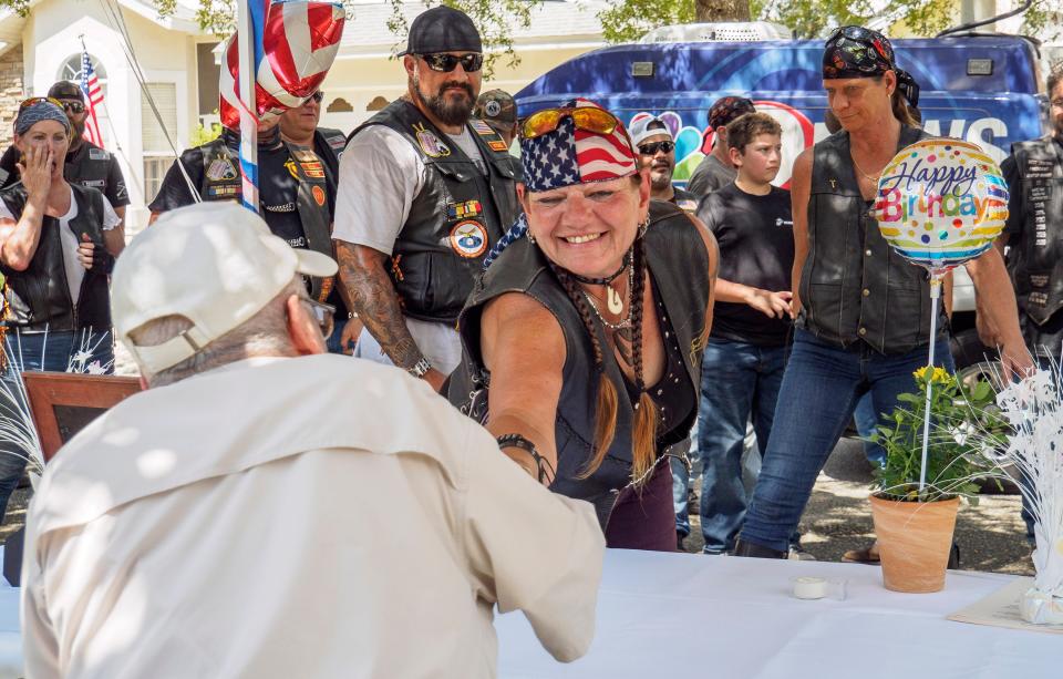 A woman shakes John Bellefontaine’s hand outside his home in Leesburg on Sunday, Sept. 6, 2020. Bellefontaine is a 95-year-old World War II veteran who fought at the Battle of the Bulge.