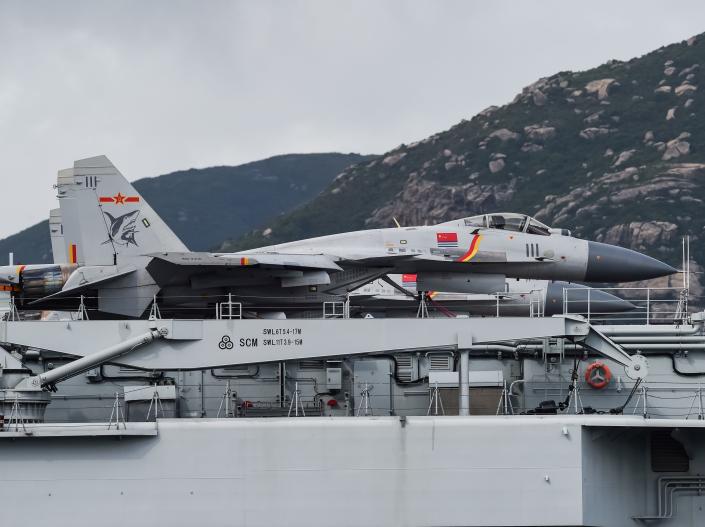 J-15 fighter jets are seen on the flight deck of China's sole aircraft carrier, the Liaoning, as it arrives in Hong Kong waters.