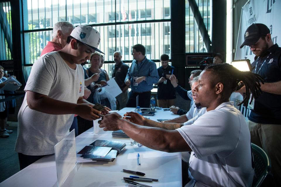 Tigers relief pitcher Gregory Soto signs autographs for Antonio De La Rosa of Oxford during the Summer Baseball Bash at Comerica Park in Detroit, Saturday, July 17, 2021.