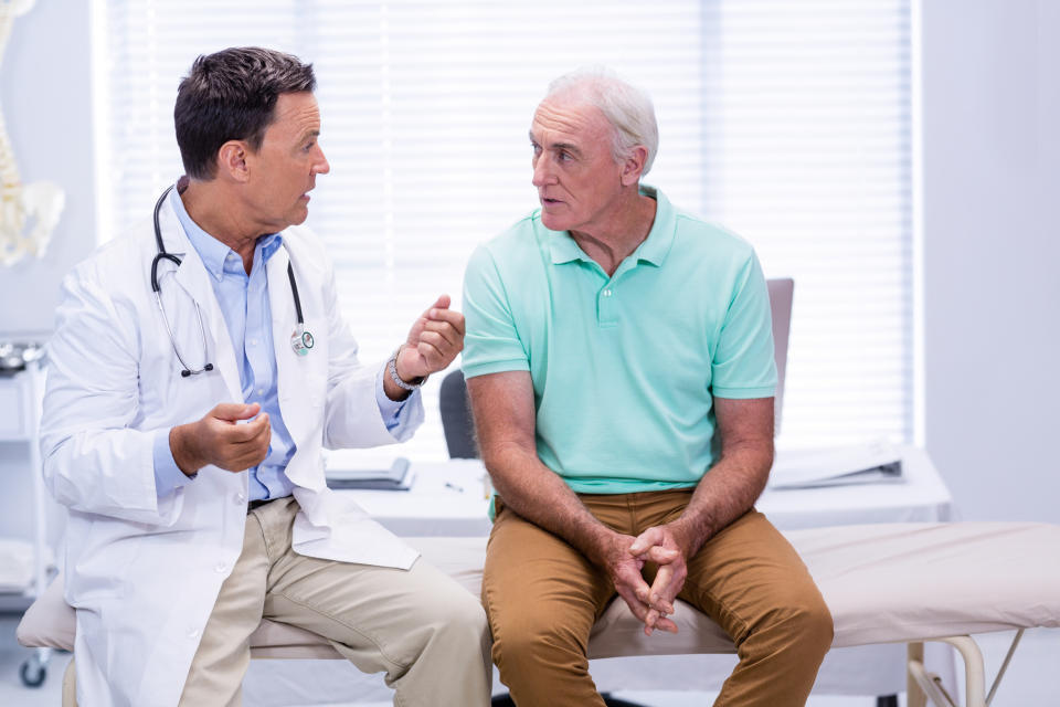 Doctor talking to older male patient