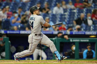 Miami Marlins' Adam Duvall follows through after hitting an RBI-sacrifice fly off Philadelphia Phillies pitcher Zack Wheeler during the fourth inning of baseball game, Tuesday, May 18, 2021, in Philadelphia. (AP Photo/Matt Slocum)