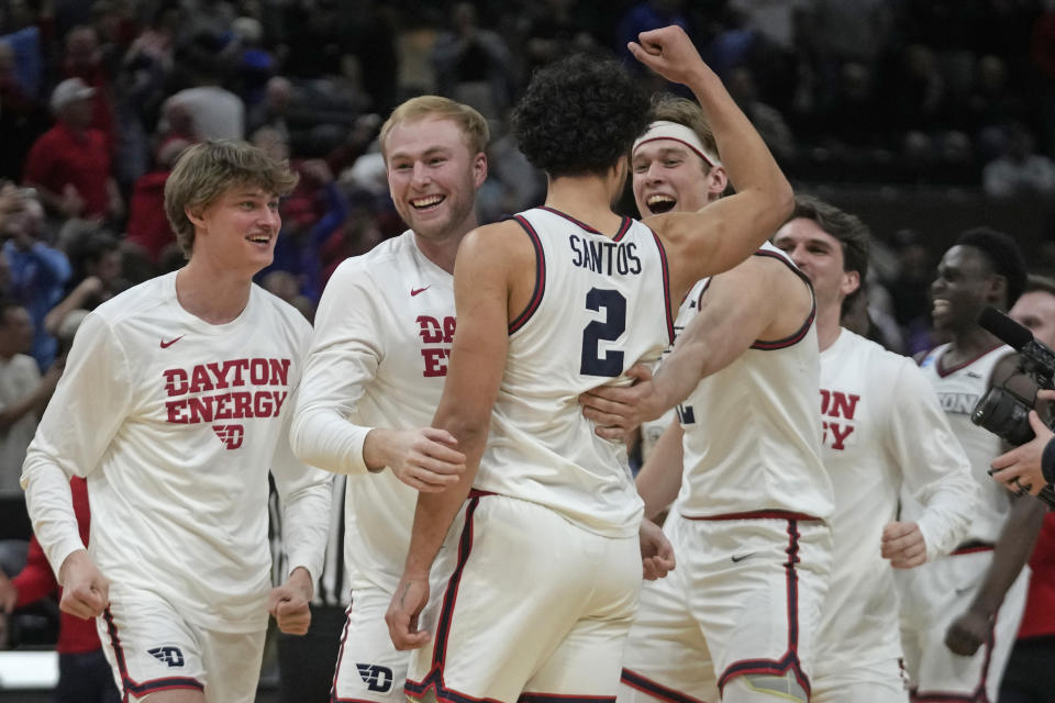 Dayton forward Nate Santos (2) celebrates with teammates following their first-round college basketball game against Nevada in the NCAA Tournament in Salt Lake City, Thursday, March 21, 2024. (AP Photo/Rick Bowmer)