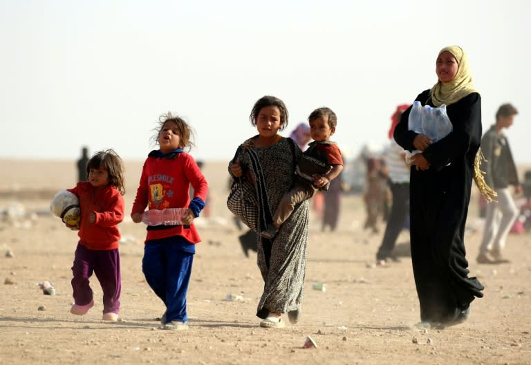 Refugees who fled Mosul, the last major Iraqi city under the control of the IS group, arrive in the desert area of Rajm al-Salibeh on the Iraq-Syria border south of al-Hawl in Syria's Hassakeh province on October 22, 2016