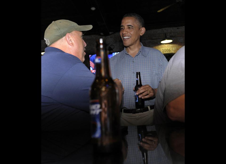 In this July 5, 2012 file photo, Obama has a beer as he talks with patrons as he stops for a beer at Ziggy's Pub and Restaurant in Amherst, Ohio. (AP Photo/Susan Walsh, File)