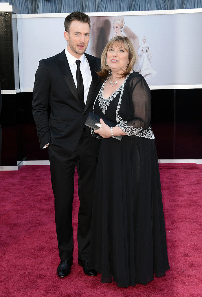 Chris in a suit with his mom on the red carpet