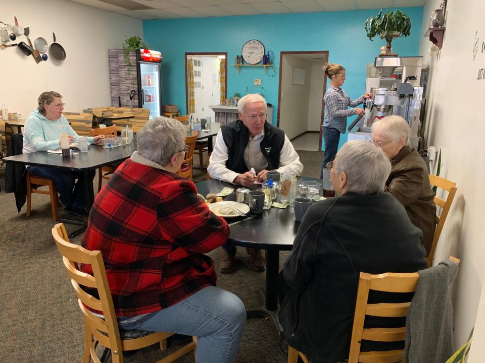 Republican presidential candidate Asa Hutchinson chats with patrons at Letz Eat restaurant during a campaign stop in Chariton, Iowa, on Nov. 30, 2023.