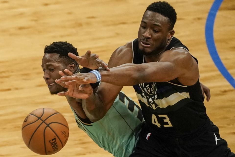 Charlotte Hornets' Terry Rozier and Milwaukee Bucks' Thanasis Antetokounmpo go after a loose ball during the first half of an NBA basketball game Friday, April 9, 2021, in Milwaukee. (AP Photo/Morry Gash)