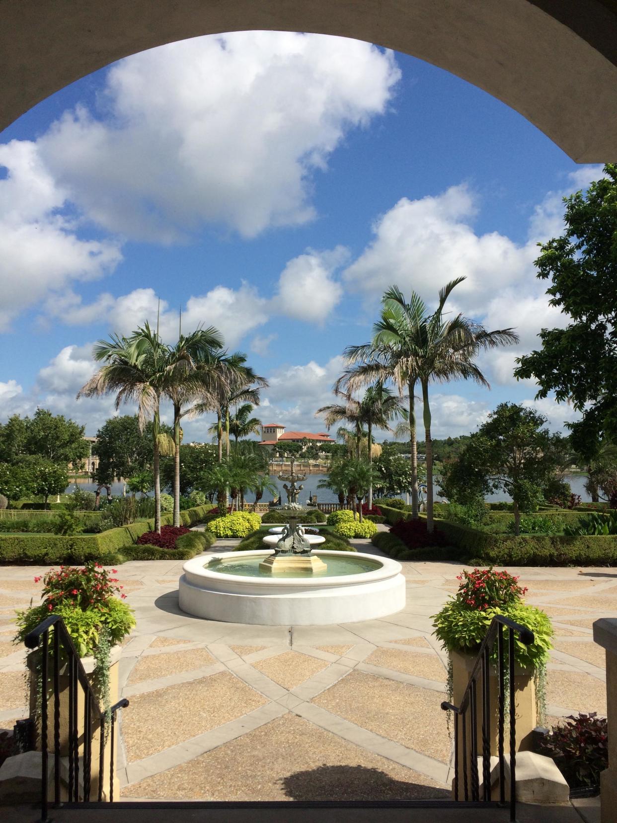 Looking out over Hollis Garden's water feature to the shore of Lake Mirror. The Lakeland Police Department is in the background.