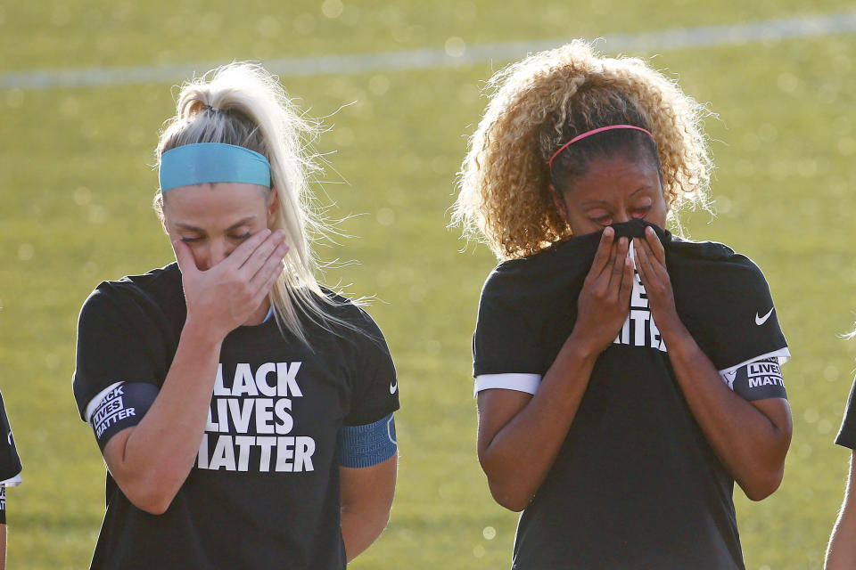 Chicago Red Stars' Julie Ertz, left, and Casey Short, cry after players for their knelt during the national anthem before an NWSL Challenge Cup soccer match against the Washington Spirit at Zions Bank Stadium, Saturday, June 27, 2020, in Herriman, Utah. (AP Photo/Rick Bowmer)