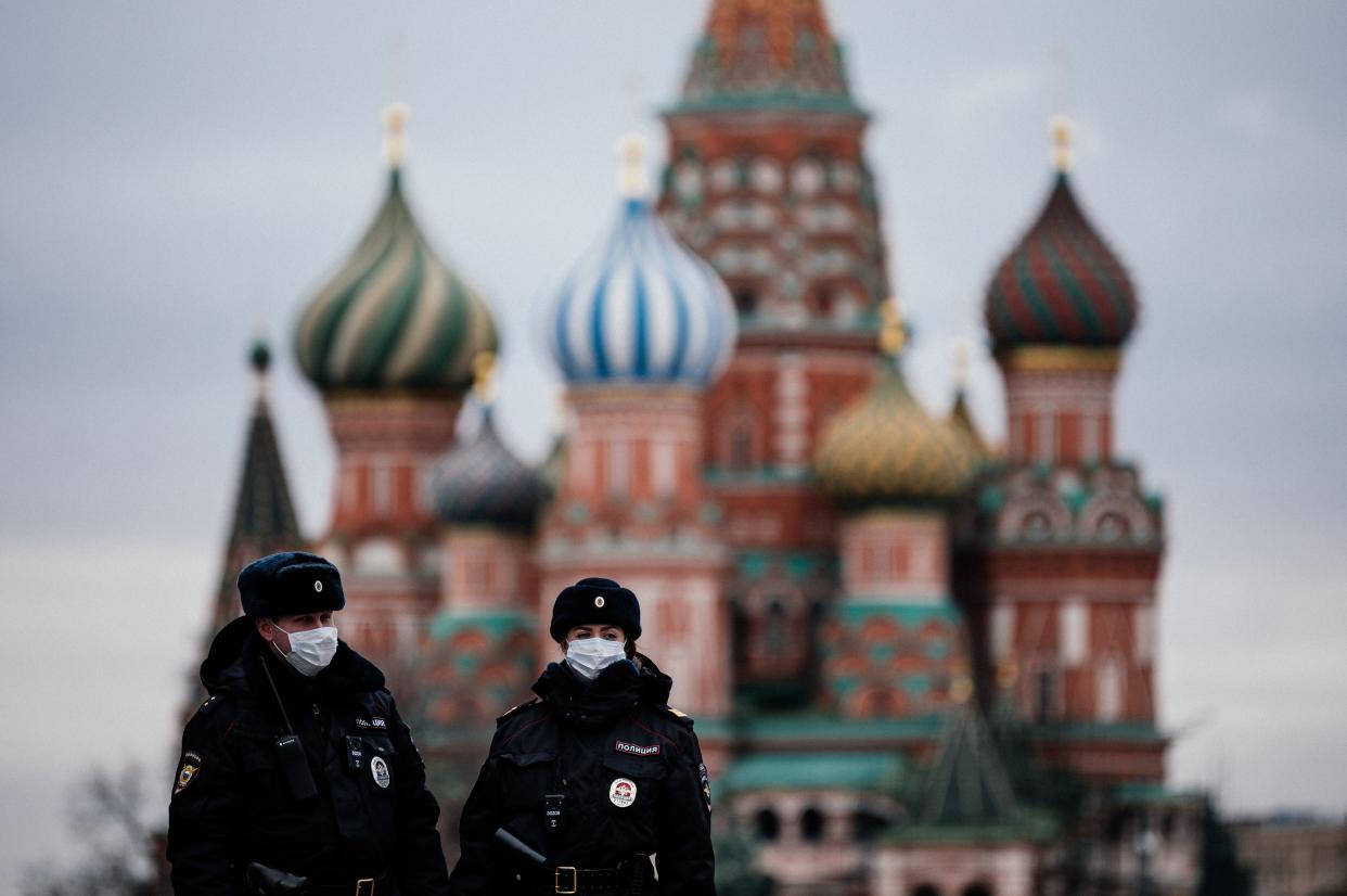 Russian police officers patrol Red Square in front of Saint Basil's Cathedral in Moscow on March 30, 2020.