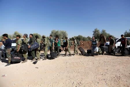 Free Syrian army fighters queue as they head towards their positions in the northern rural area of Aleppo, Syria, September 26, 2016. REUTERS/Khalil Ashawi