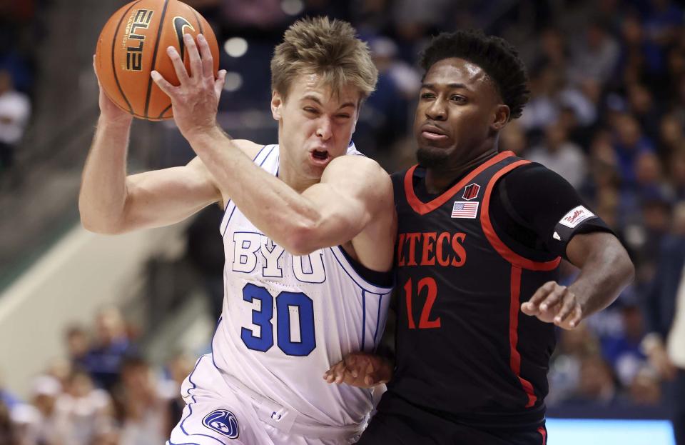 BYU guard Dallin Hall drives into San Diego State Aztecs guard Darrion Trammell as BYU and San Diego State compete at BYU’s Marriott Center in Provo on Friday, Nov. 10, 2023. The Cougars are now ranked No. 19 in the AP Top 25. | Laura Seitz, Deseret News