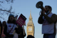 A protestor with a megaphone shouts slogans in front of Big Ben as nurses of the nearby St. Thomas' Hospital protest in London, Monday, Feb. 6, 2023. Tens of thousands of nurses and ambulance staff are walking off the job in the U.K. in what unions called the biggest strike in the history of the country's public health system. (AP Photo/Frank Augstein)