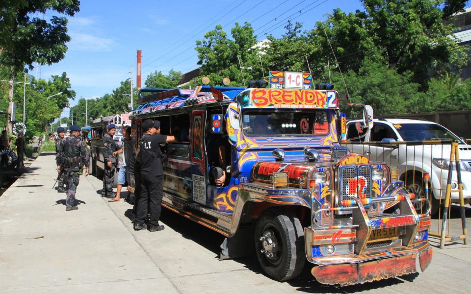 Filipino soldiers check a vehicle with evacuating residents from their hometown of Marawi city, at a military checkpoint in Iligan city, Mindanao - Credit: RICHEL UMEL/EPA