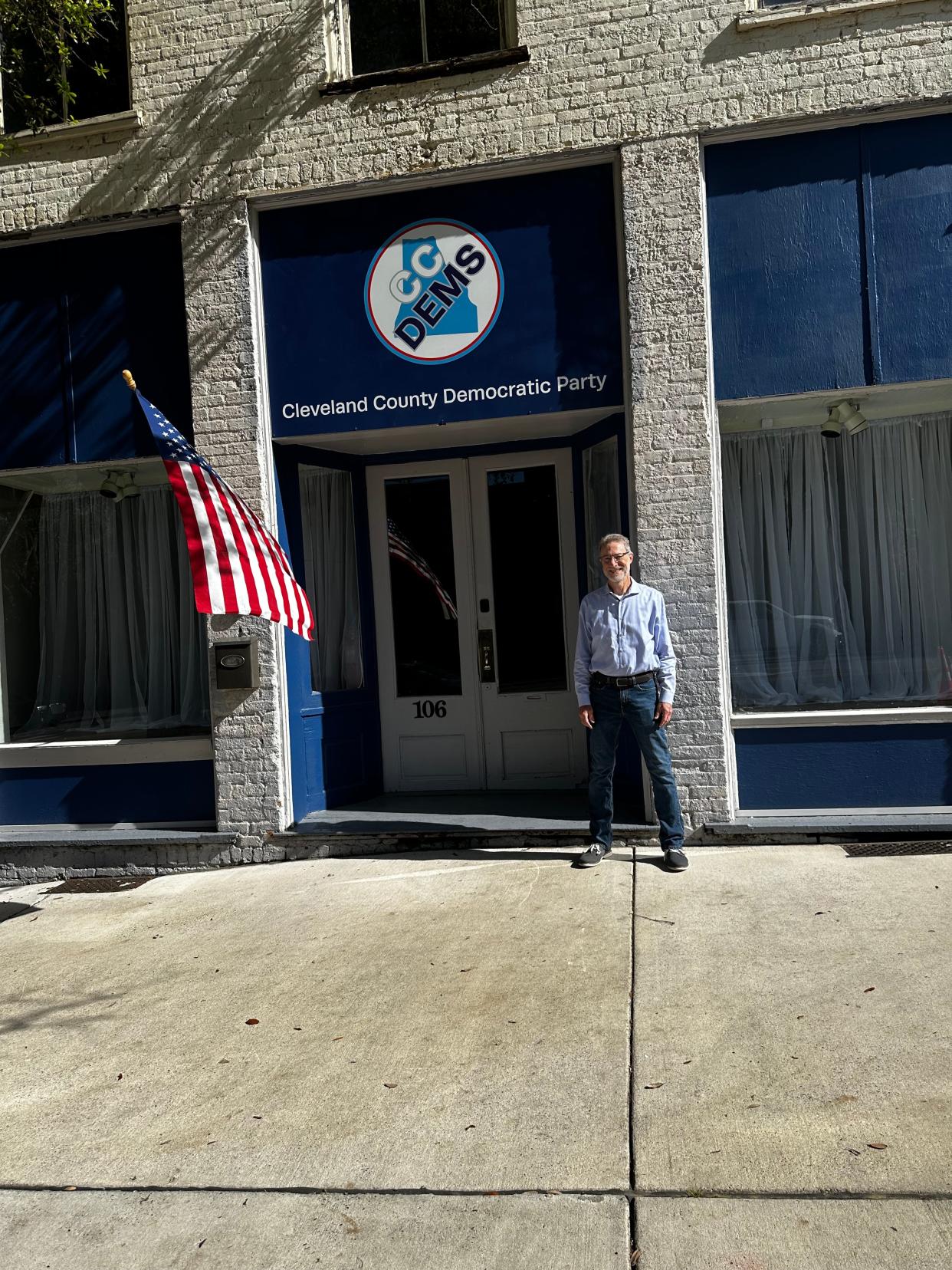 Kent Blevins, chair of the Cleveland County Democratic Party, stands in front of their new headquarters on Marion Street.