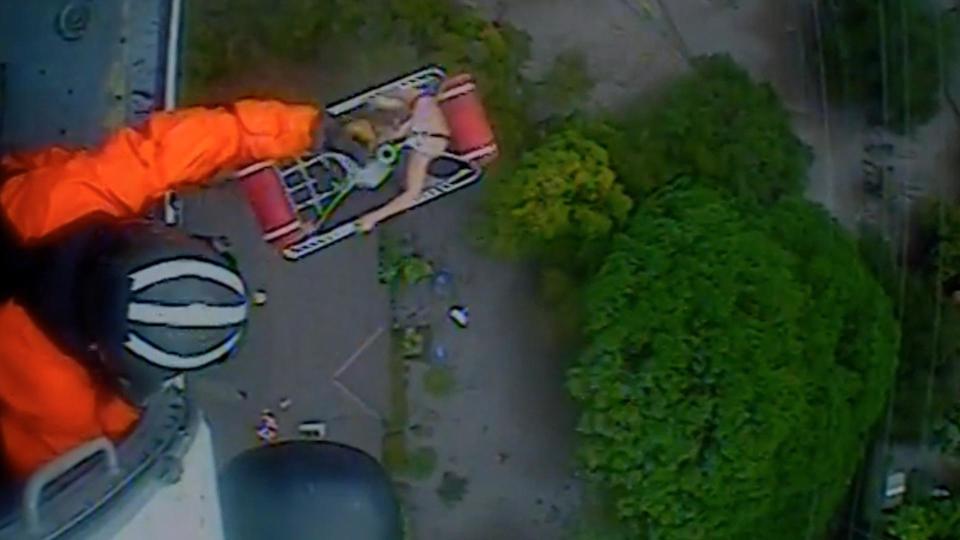 California mudslides: Video shows rooftop rescue of San Diego family of five and their dogs