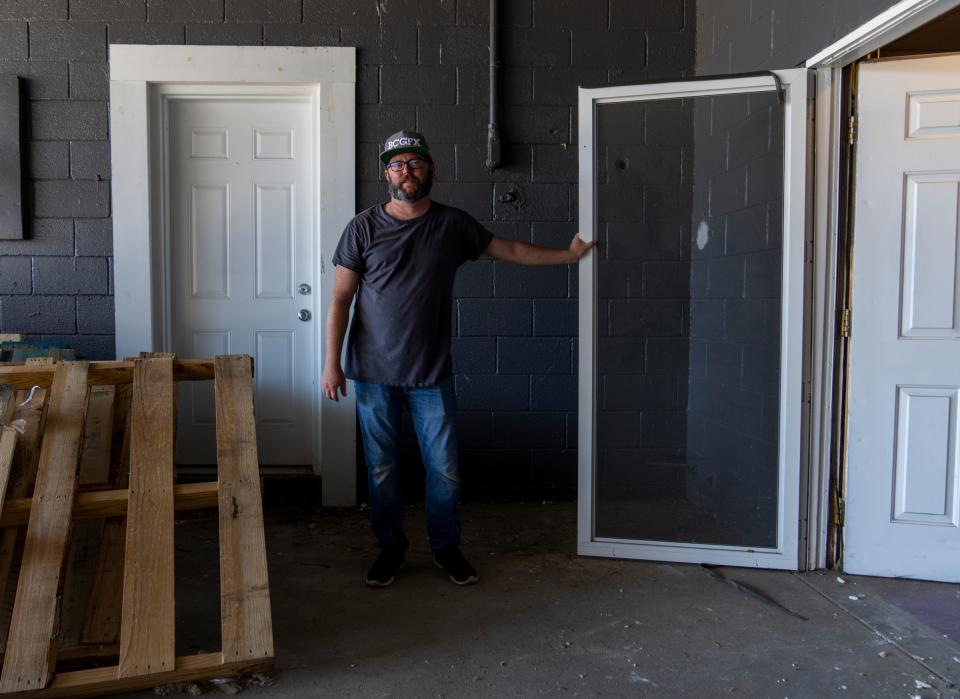 Ronan Marra, creative director, on a loading dock Indianapolis, Tuesday, June 21, 2022, at the under-construction location of Storefront Theater. 