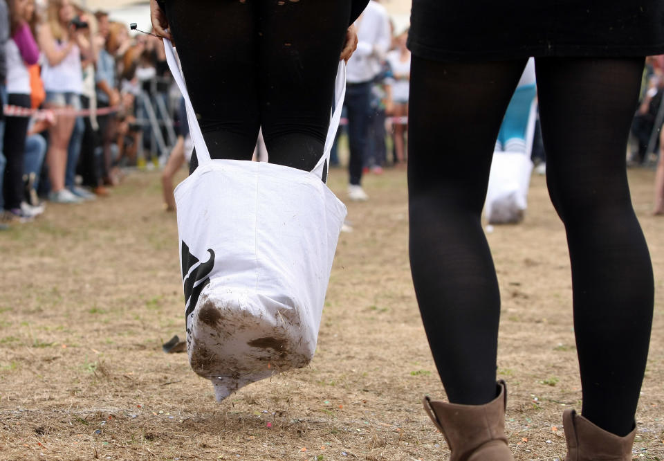 BERLIN, GERMANY - JULY 21: Contestants compete in the Cloth Tote Sack Race during the second annual Hipster Olympics on July 21, 2012 in Berlin, Germany. With events such as the "Horn-Rimmed Glasses Throw," "Skinny Jeans Tug-O-War," "Vinyl Record Spinning Contest" and "Cloth Tote Sack Race," the Hipster Olympics both mocks and celebrates the Hipster subculture, which some critics claim could never be accurately defined and others that it never existed in the first place. The imprecise nature of determining what makes one a member means that the symptomatic elements of adherants to the group vary in each country, but the archetype of the version in Berlin, one of the more popular locations for those following its lifestyle, along with London and Brooklyn, includes a penchant for canvas tote bags, the carbonated yerba mate drink Club Mate, analogue film cameras, asymmetrical haircuts, 80s neon fashion, and, allegedly, a heavy dose of irony. To some in Berlin, members of the hipster "movement" have replaced a former unwanted identity in gentrifying neighborhoods, the Yuppie, for targets of criticism, as landlords raise rents in the areas to which they relocate, particularly the up-and-coming neighborhood of Neukoelln. (Photo by Adam Berry/Getty Images)