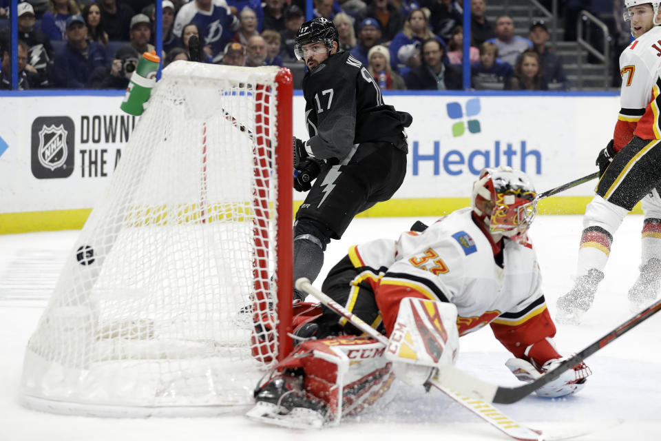 Tampa Bay Lightning left wing Alex Killorn (17) watches his goal get past Calgary Flames goaltender David Rittich (33) during the second period of an NHL hockey game Saturday, Feb. 29, 2020, in Tampa, Fla. (AP Photo/Chris O'Meara)