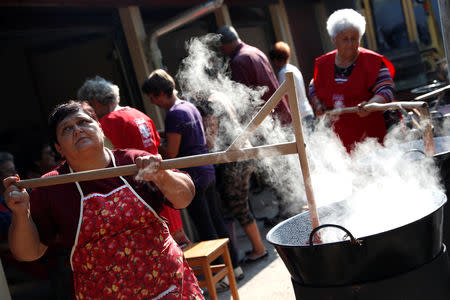 Elderly women cook plum marmalade in Bordany, Hungary, September 19, 2018. REUTERS/Bernadett Szabo
