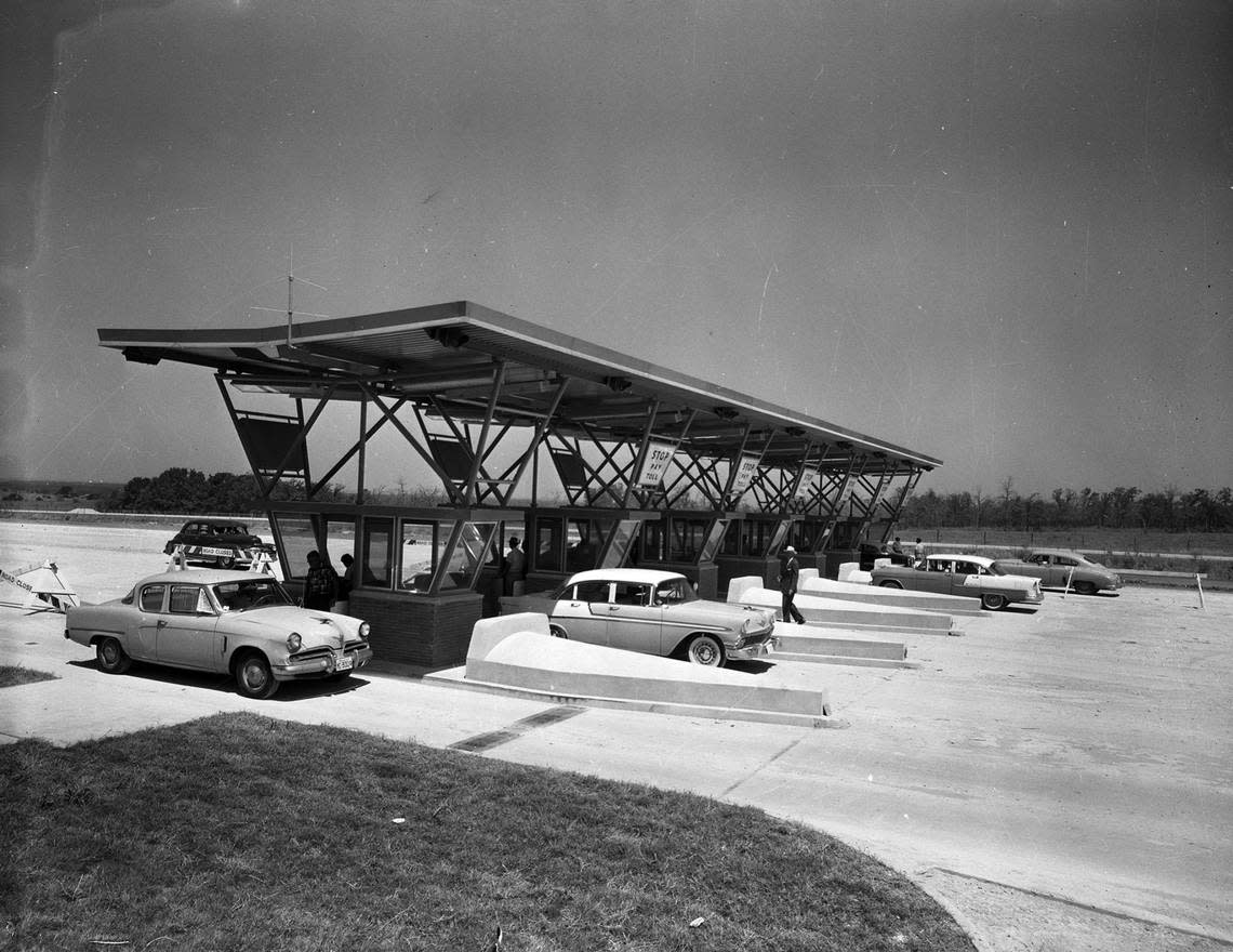 Cars making practice runs at the new Fort Worth-Dallas Turnpike toll gates on Aug. 7, 1957, about three weeks before opening the freeway opened.
