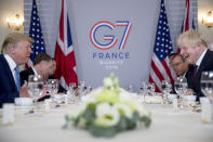 President Donald Trump and Britain's Prime Minister Boris Johnson, right, attend a working breakfast at the Hotel du Palais on the sidelines of the G-7 summit in Biarritz, France, Sunday, Aug. 25, 2019. (AP Photo/Andrew Harnik)