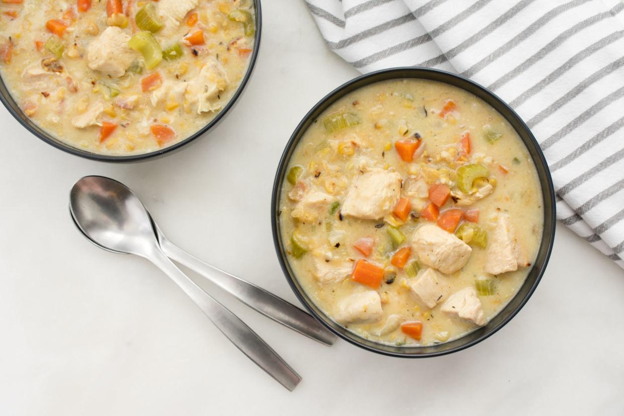 Bowls of chowder with spoons and a napkin