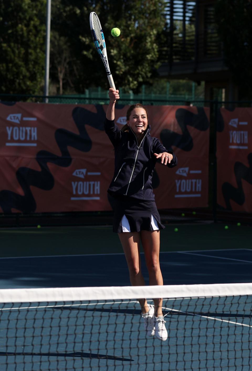 <p>Kate Middleton reaches for the shot on Sept. 24 as British US Open champions Emma Raducanu, Joe Salisbury, Gordon Reid and Alfie Hewett return to the LTA's National Tennis Centre for a celebration in London.</p>