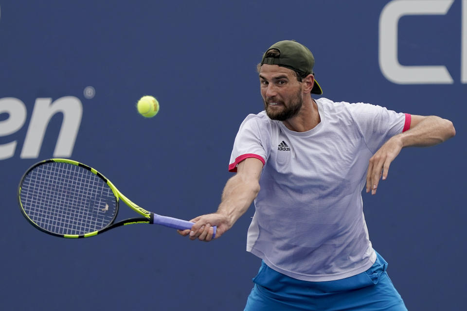 Maxime Cressy, of the United States, returns a shot to Pablo Carreno Busta, of Spain, during the first round of the US Open tennis championships, Tuesday, Aug. 31, 2021, in New York. (AP Photo/Seth Wenig)