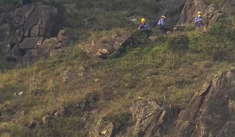 Firefighters were sent up the hill to rescue the woman. Photo: TVB News