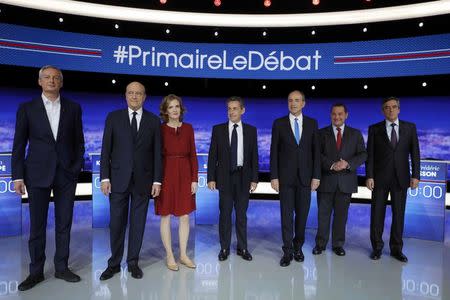 From L-R, French politicians Bruno Le Maire, Alain Juppe, Nathalie Kosciusko-Morizet, Nicolas Sarkozy, Jean-Francois Cope, Jean-Frederic Poisson and Francois Fillon pose before the first prime-time televised debate for the French conservative presidential primary in La Plaine Saint-Denis, near Paris, France, October 13, 2016. REUTERS/Philippe Wojazer