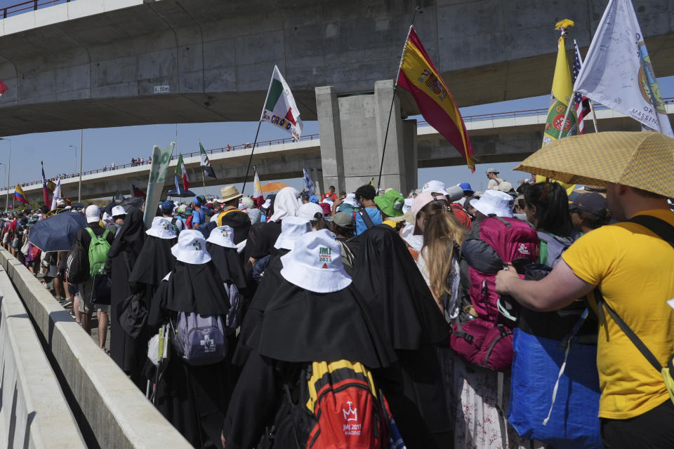 Pilgrims leave Parque Tejo in Lisbon where Pope Francis presided over a mass celebrating the 37th World Youth Day, Sunday, Aug. 6, 2023. An estimated 1.5 million young people filled the parque on Saturday for Pope Francis' World Youth Day vigil, braving scorching heat to secure a spot for the evening prayer and to camp out overnight for his final farewell Mass on Sunday morning. (AP Photo/Ana Brigida)