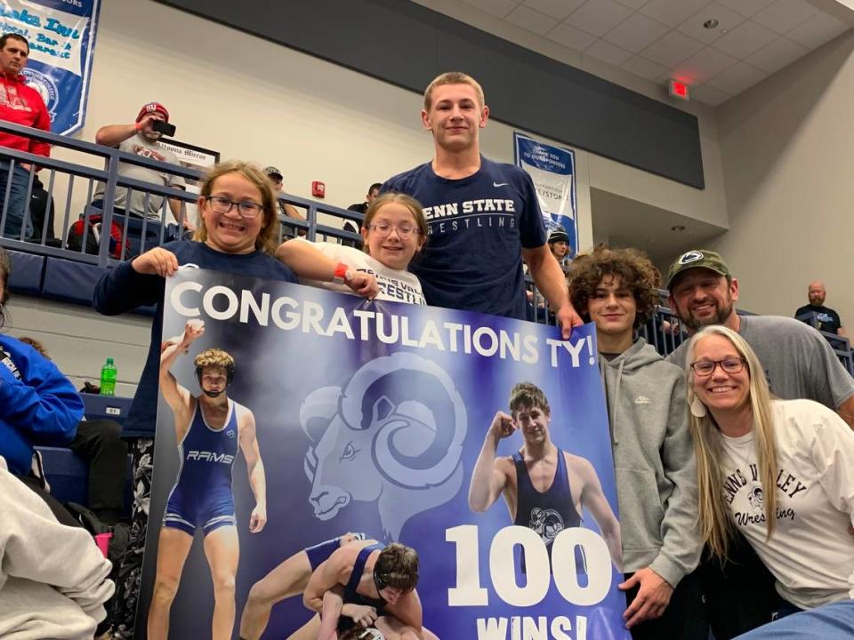 Penns Valley’s Ty Watson celebrates his 100th career win his family on Friday night. From left, sisters, Taylinn and Tessa; Watson, brother, Tripp, father, Mike and mother, Kennette.