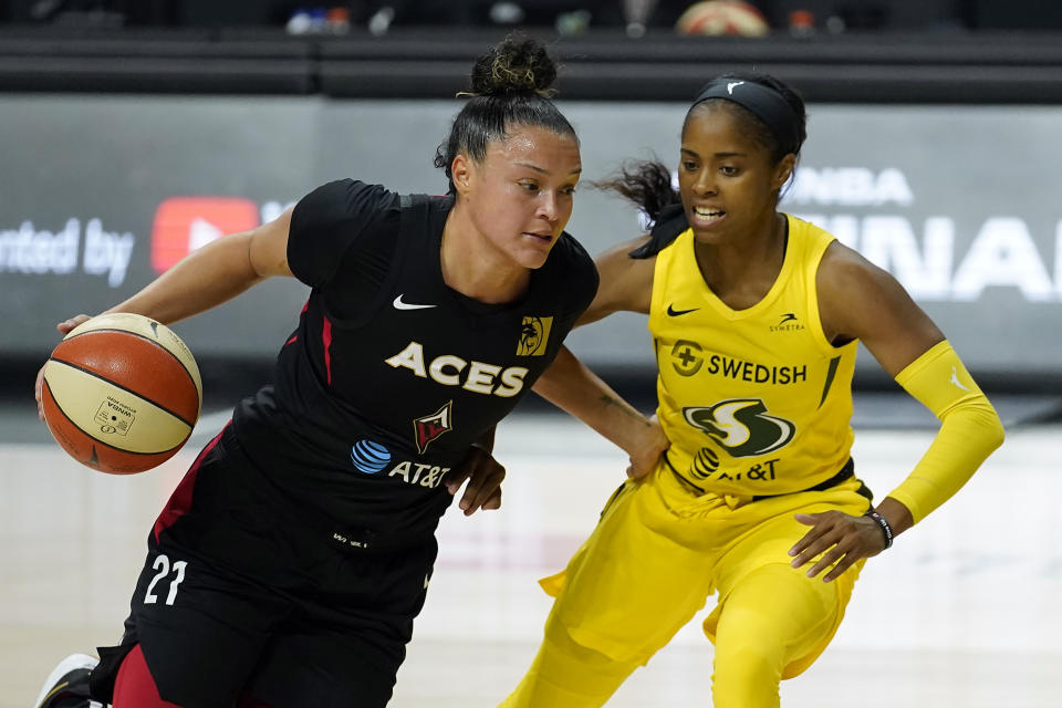 Las Vegas Aces guard Kayla McBride, left, drives around Seattle Storm guard Jordin Canada during the first half of Game 1 of basketball's WNBA Finals Friday, Oct. 2, 2020, in Bradenton, Fla. (AP Photo/Chris O'Meara)