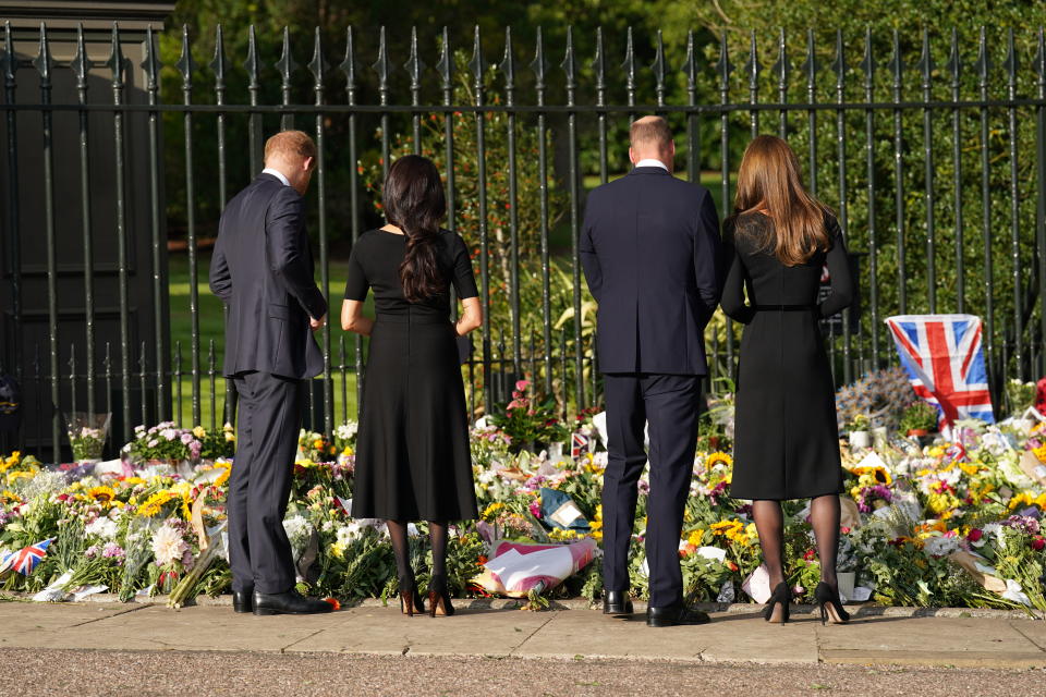 <p>From left: Prince Harry, Duke of Sussex; Meghan, Duchess of Sussex; Prince William, Prince of Wales; and Catherine, Princess of Wales view floral tributes left at Windsor Castle on Sept. 10, 2022 in England. (Photo by Kirsty O'Connor - WPA Pool/Getty Images)</p> 