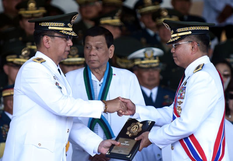 FILE PHOTO: Philippine President Rodrigo Duterte looks on during AFP ceremony in Quezon City